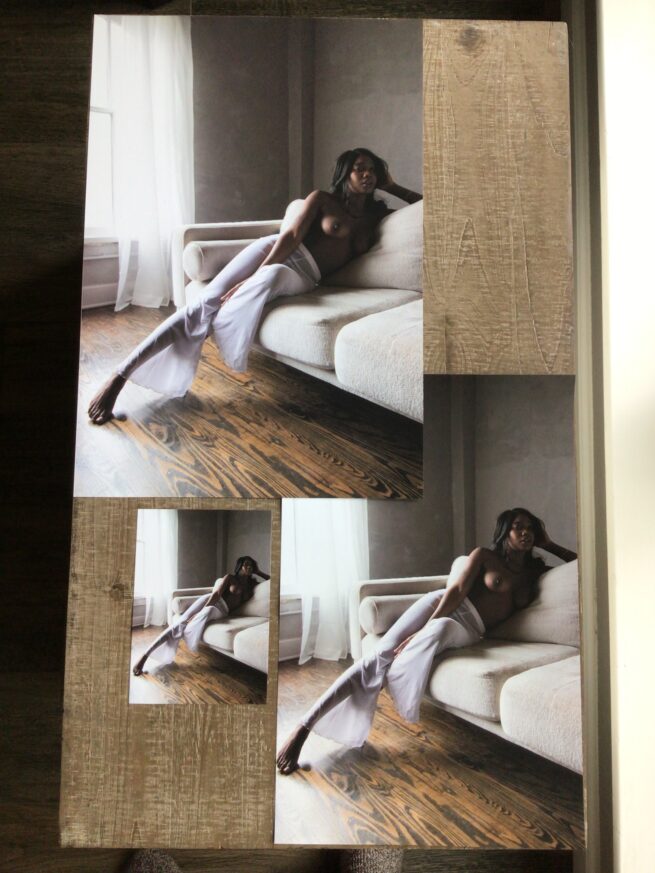 Poster prints of a beautiful dark-skinned black woman topless lounging on a couch